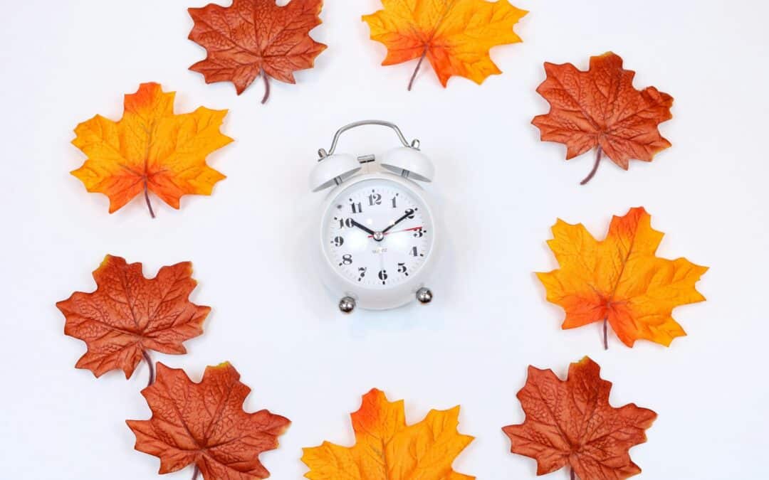 silver and white analog alarm clock