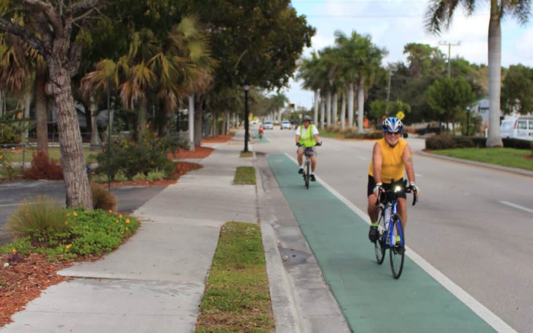 People walking and biking on a separated pathway in Collier County