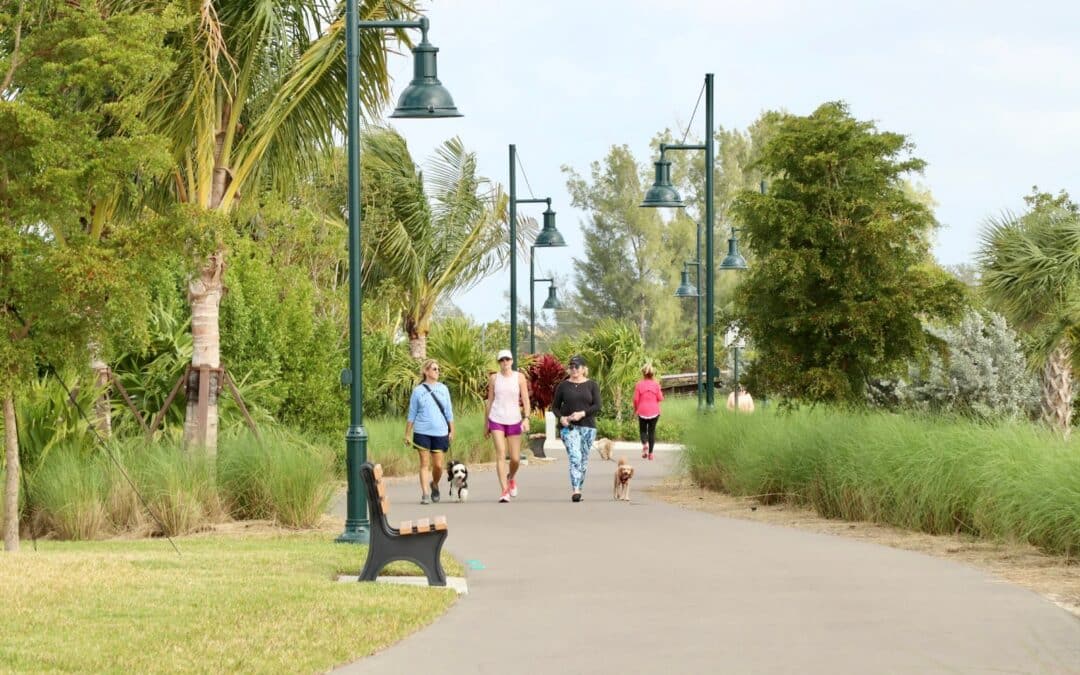 People walking on a shaded pathway in Naples, Florida